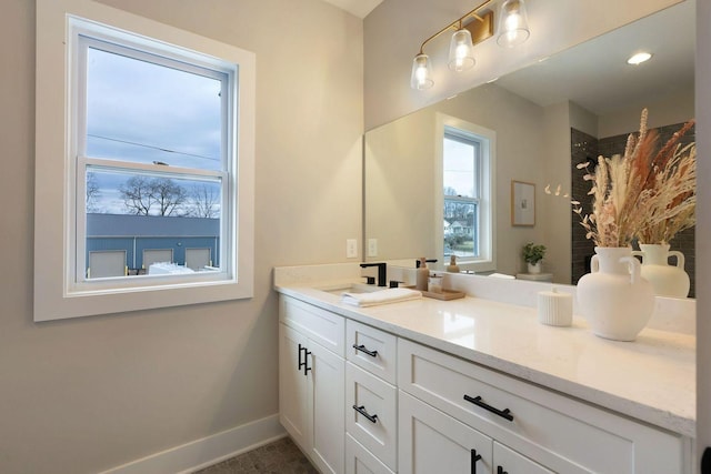 bathroom featuring a shower with curtain, baseboards, and vanity