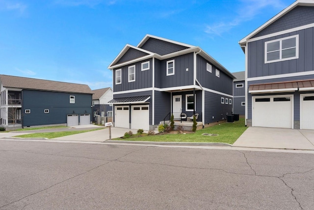 view of front of house with board and batten siding, a front yard, concrete driveway, and an attached garage