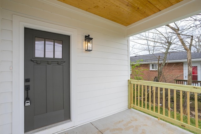 view of exterior entry with covered porch