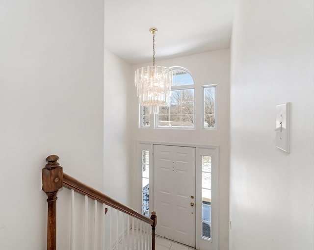 entrance foyer featuring a chandelier and a high ceiling