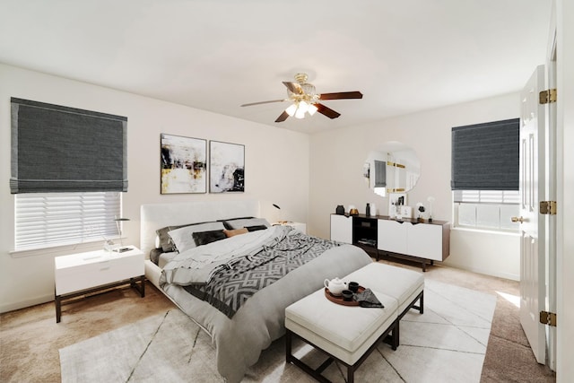 bedroom featuring baseboards, a ceiling fan, and light tile patterned flooring