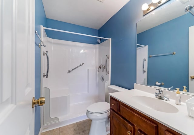 full bath with toilet, tile patterned flooring, a shower, and vanity