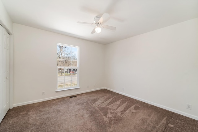 unfurnished bedroom with carpet, visible vents, baseboards, and a closet