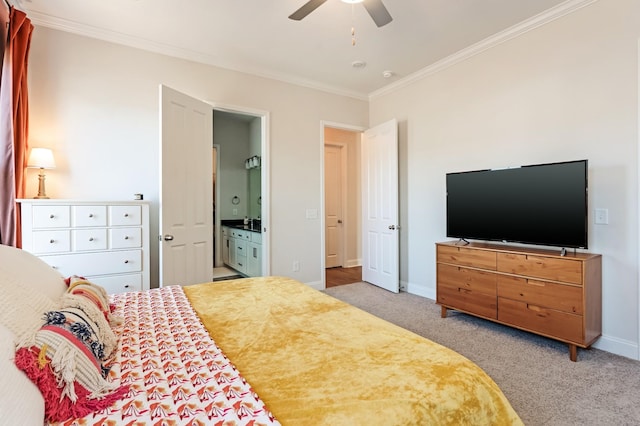 bedroom featuring carpet floors, ornamental molding, connected bathroom, ceiling fan, and baseboards