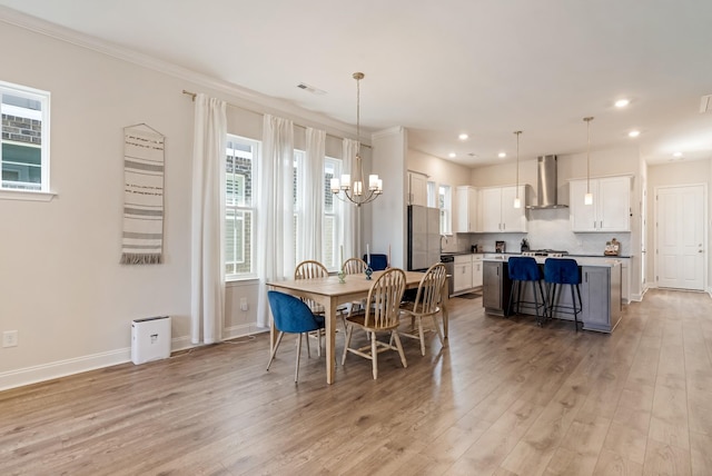 dining space with recessed lighting, visible vents, baseboards, light wood-type flooring, and an inviting chandelier