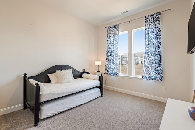 bedroom featuring carpet floors, visible vents, and baseboards