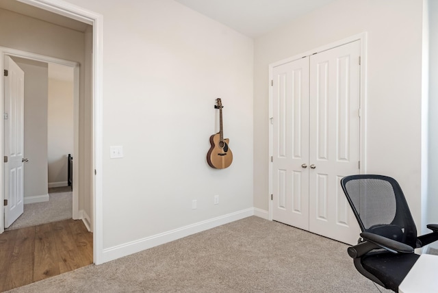 unfurnished office featuring carpet and baseboards