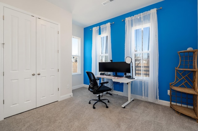 carpeted home office featuring visible vents and baseboards