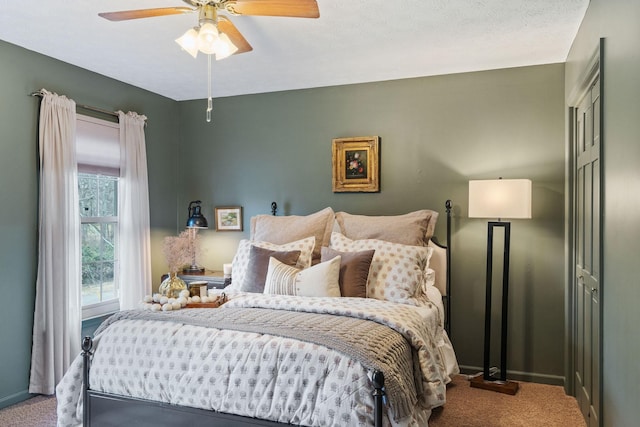 carpeted bedroom featuring ceiling fan and baseboards