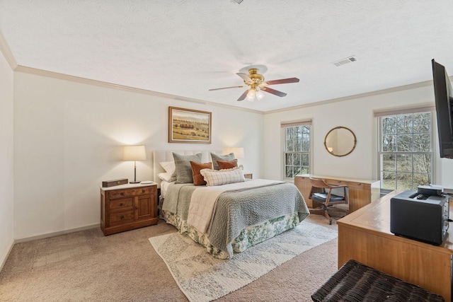 bedroom with a textured ceiling, ornamental molding, visible vents, and light colored carpet