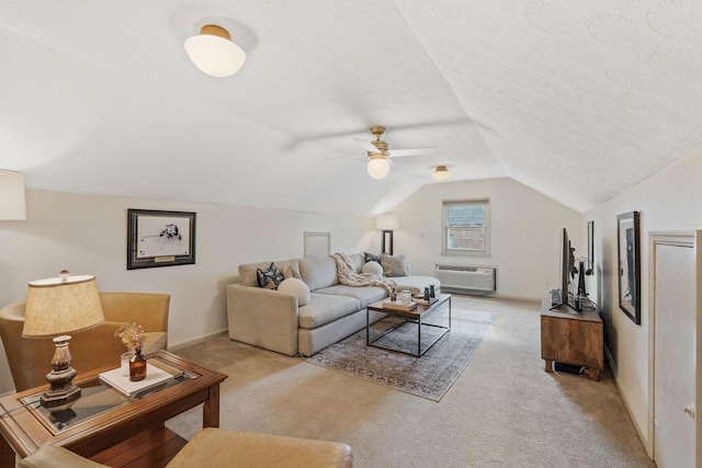 living area featuring carpet floors, vaulted ceiling, a textured ceiling, and a wall mounted air conditioner