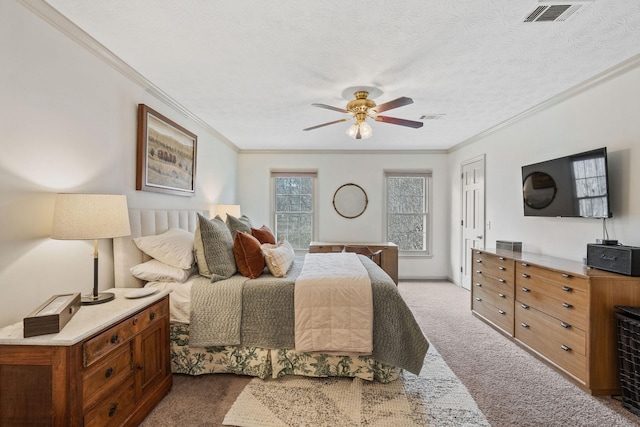 bedroom with crown molding, a textured ceiling, visible vents, and carpet flooring