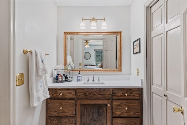 ensuite bathroom with ceiling fan, vanity, and ensuite bath