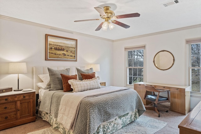 bedroom featuring light carpet, ornamental molding, visible vents, and a ceiling fan