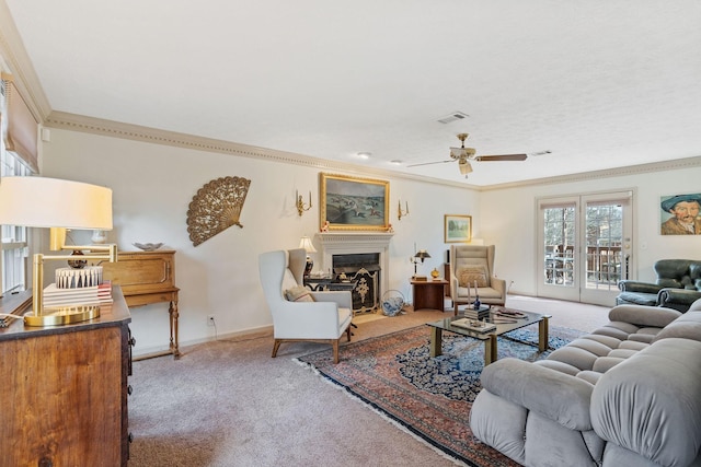 living room with ornamental molding, carpet, a fireplace, and visible vents