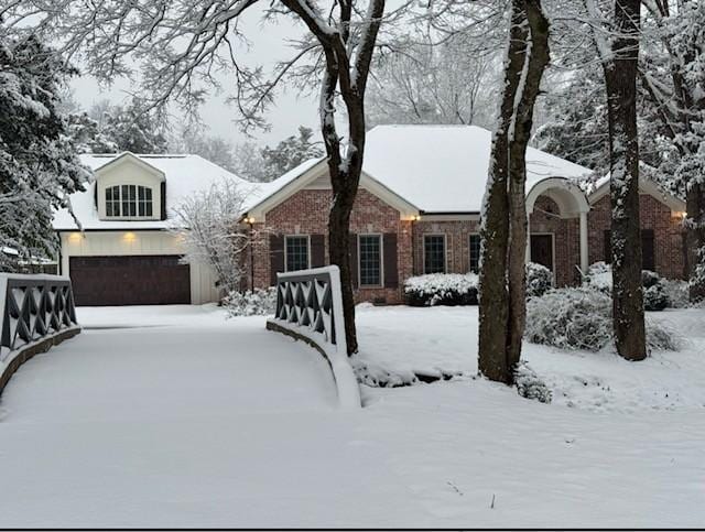 view of front facade featuring a garage and brick siding