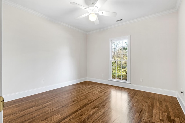 empty room featuring baseboards, visible vents, dark wood finished floors, and ornamental molding