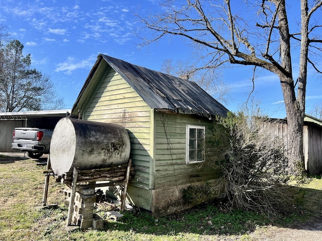 view of outbuilding featuring heating fuel and a carport