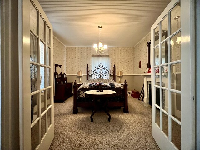 carpeted dining area featuring ornamental molding, french doors, an inviting chandelier, and wallpapered walls