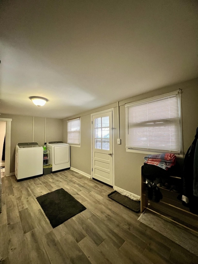 entrance foyer featuring wood finished floors, washing machine and dryer, and baseboards