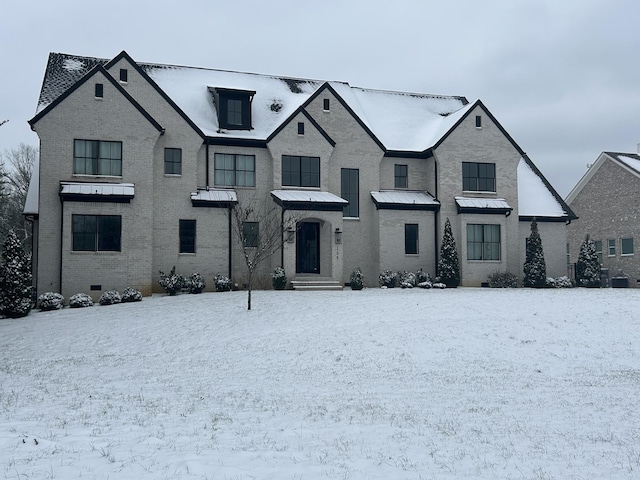 view of front of property featuring crawl space, brick siding, and metal roof