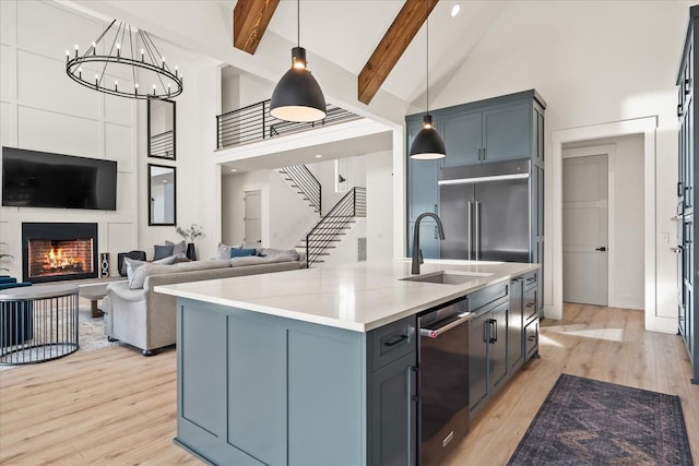 105 Stillwind Ct, Nolensville, TN 37135 - kitchen with high vaulted ceiling, beamed ceiling, light wood-type flooring, appliances with stainless steel finishes, and a sink
