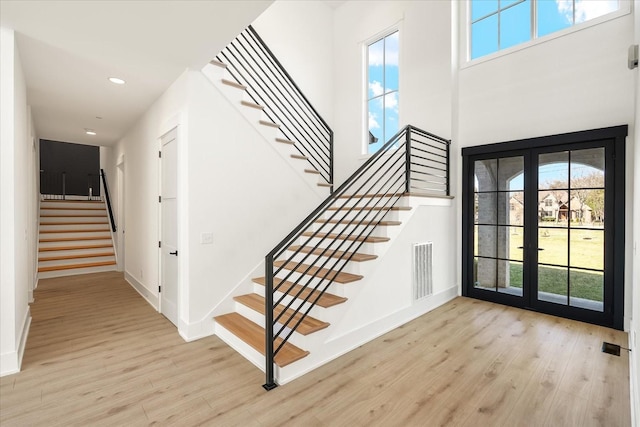 105 Stillwind Ct, Nolensville, TN 37135 - entrance foyer with french doors, wood finished floors, plenty of natural light, and stairway