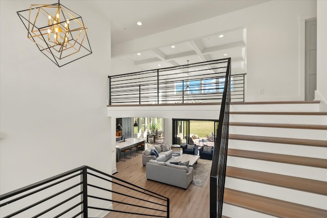 105 Stillwind Ct, Nolensville, TN 37135 - stairs with a notable chandelier, a high ceiling, beam ceiling, recessed lighting, and wood finished floors