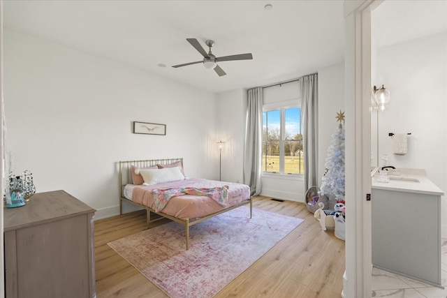 105 Stillwind Ct, Nolensville, TN 37135 - bedroom with baseboards, a ceiling fan, light wood-style floors, visible vents, and a sink