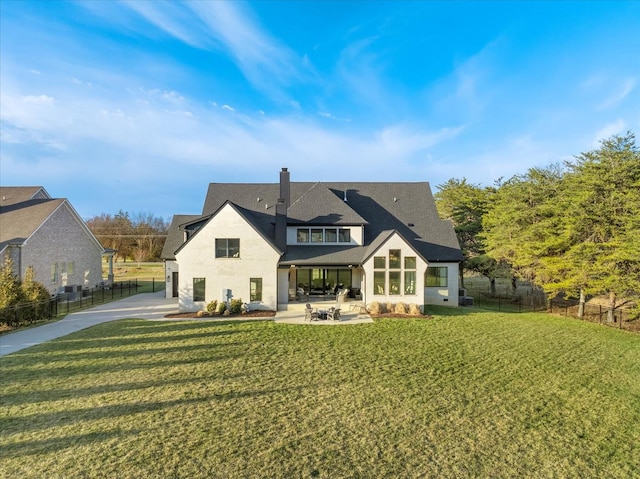 105 Stillwind Ct, Nolensville, TN 37135 - back of property featuring a shingled roof, a patio area, a yard, a chimney, and fence