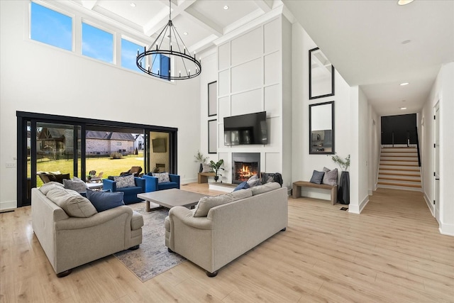 105 Stillwind Ct, Nolensville, TN 37135 - living room featuring a healthy amount of sunlight, light wood finished floors, a towering ceiling, and beam ceiling