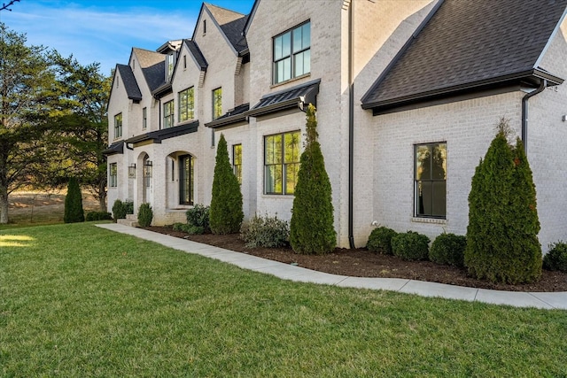 105 Stillwind Ct, Nolensville, TN 37135 - view of home's exterior with roof with shingles, a yard, brick siding, and a residential view