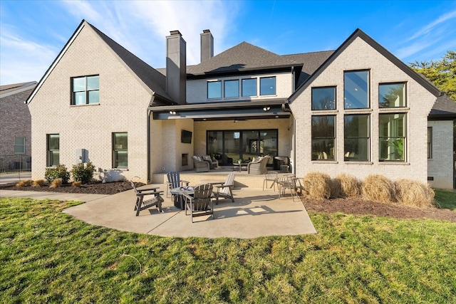 105 Stillwind Ct, Nolensville, TN 37135 - rear view of house featuring a patio area, outdoor lounge area, a chimney, and a yard