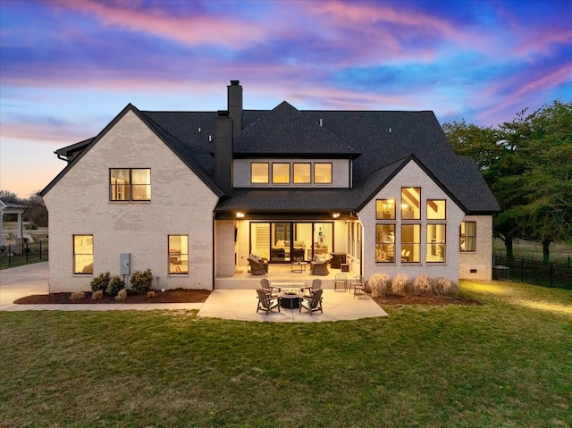 105 Stillwind Ct, Nolensville, TN 37135 - back of house at dusk featuring roof with shingles, a chimney, a patio area, fence, and a lawn