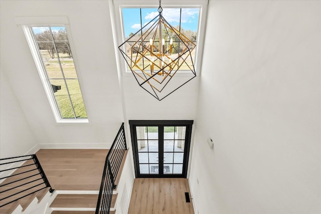 105 Stillwind Ct, Nolensville, TN 37135 - doorway to outside with an inviting chandelier, wood finished floors, and a healthy amount of sunlight