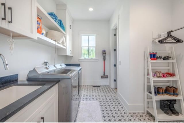 105 Stillwind Ct, Nolensville, TN 37135 - laundry area with light floors, a sink, washer and dryer, baseboards, and cabinet space