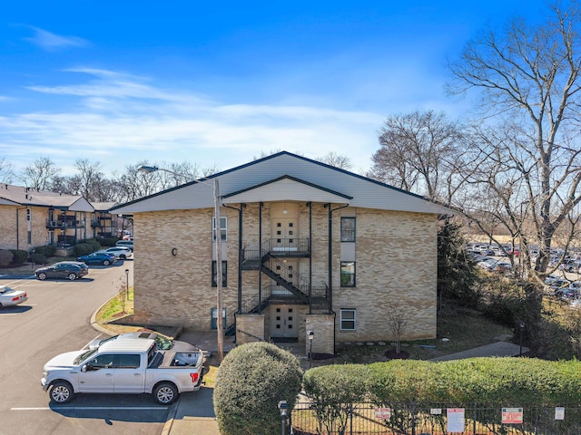 exterior space with uncovered parking and fence