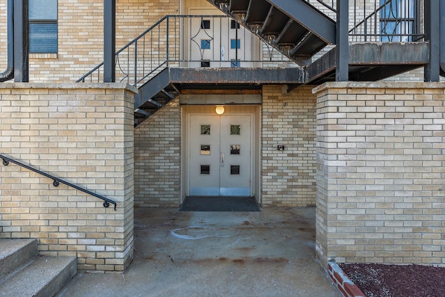 view of exterior entry with brick siding