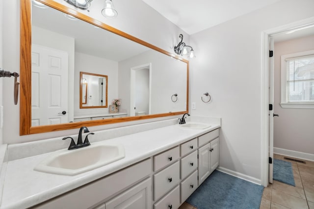 bathroom with tile patterned flooring, visible vents, a sink, and double vanity