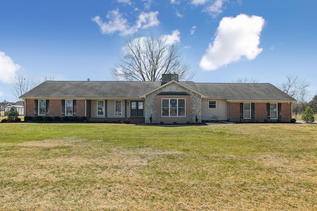 single story home with a front lawn, a chimney, and brick siding