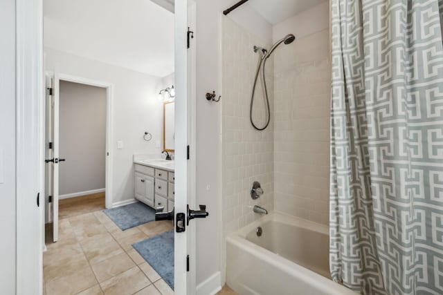 bathroom featuring tile patterned flooring, shower / bath combination with curtain, vanity, and baseboards