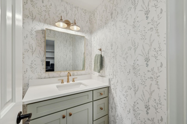 bathroom with vanity and wallpapered walls