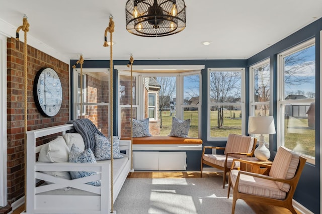 sunroom / solarium with a chandelier