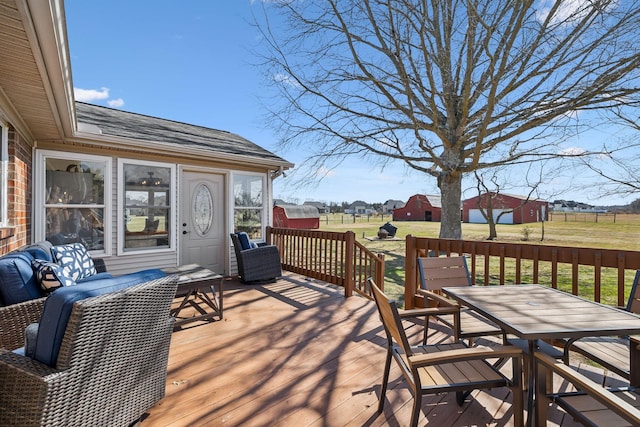 deck with a lawn and outdoor dining space