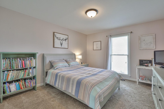 carpeted bedroom with baseboards