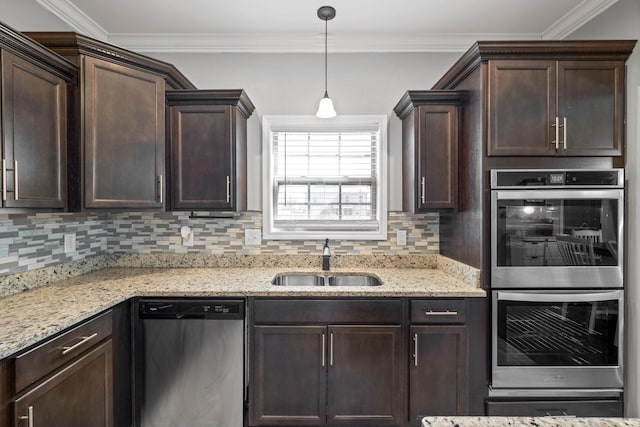 kitchen with decorative backsplash, appliances with stainless steel finishes, crown molding, dark brown cabinets, and a sink