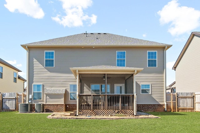 rear view of house featuring a sunroom, fence, central AC unit, and a lawn