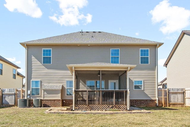 back of property featuring a sunroom, central AC, fence, and a lawn