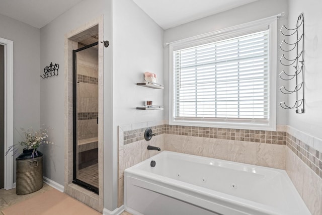 bathroom featuring a stall shower and a jetted tub