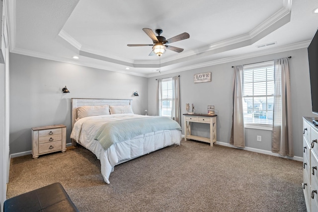 bedroom featuring carpet floors, a raised ceiling, and baseboards